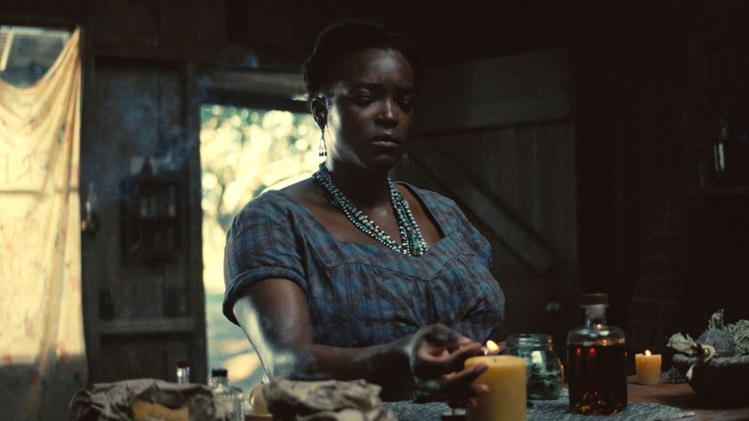 Wunmi Mosaku lights a candle as she prepares a ritual in Sinners.