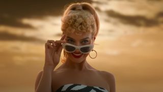 Margot Robbie as Barbie, peeking over her sunglasses
