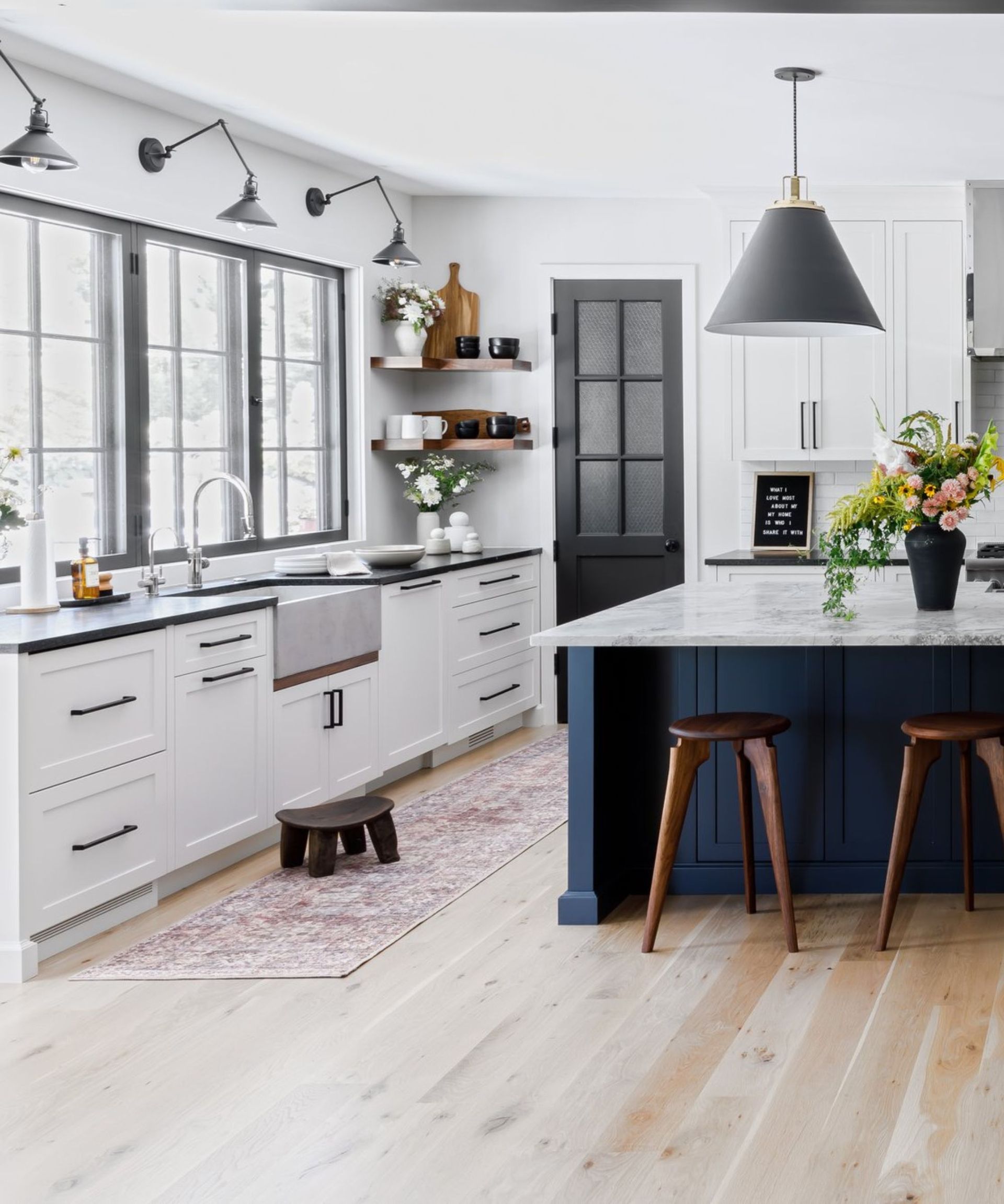 A white kitchen with granite countertops
