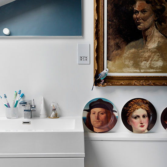 bathroom with wash basin and painting on wall