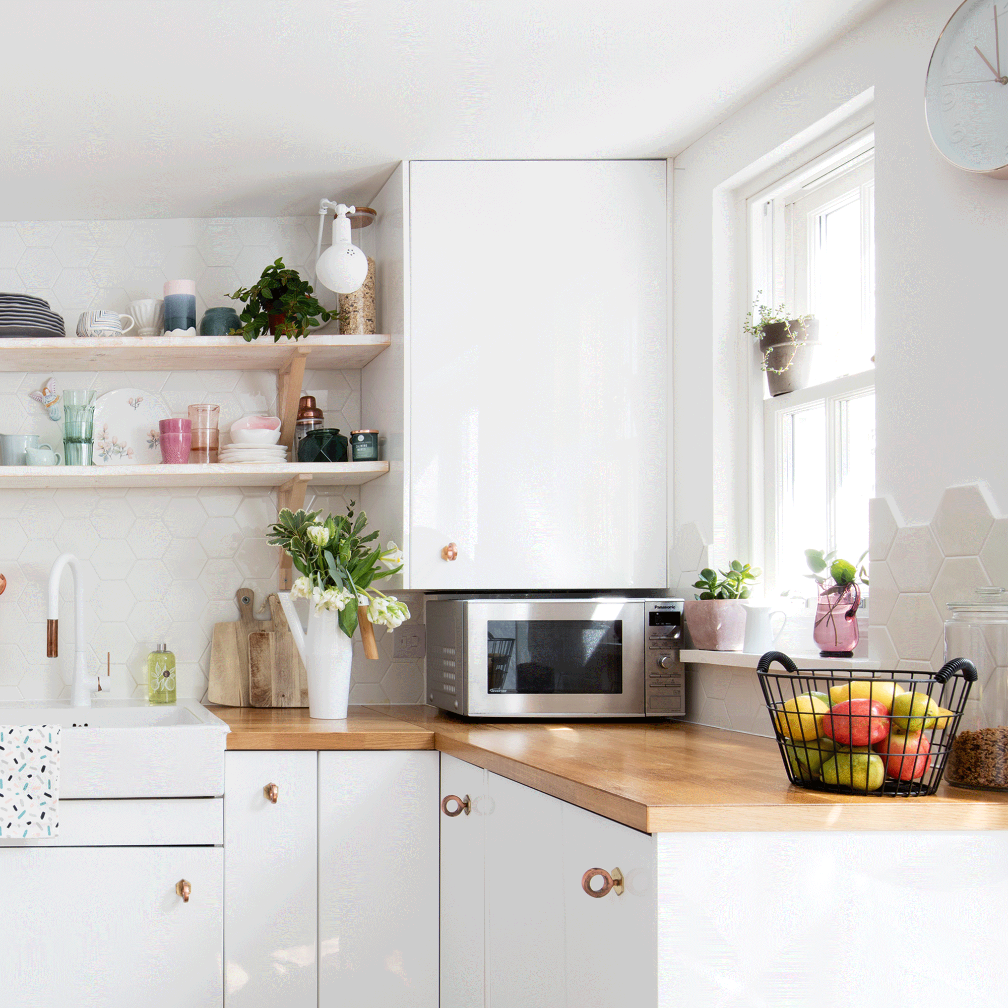 White kitchen with wooden counters and microwave