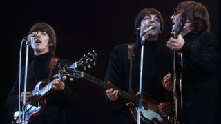 George Harrison (1943-2001), Paul McCartney and John Lennon (1940-1980) of The Beatles perform at Empire Pool in Wembley at the New Musical Express Annual Poll Winner's Concert in what would be their final scheduled performance in England, on May 1, 1966, in London, U