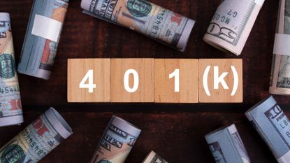 Wooden blocks spelling out "401(k)" are surrounded by rolls of $100 and $50 bills.