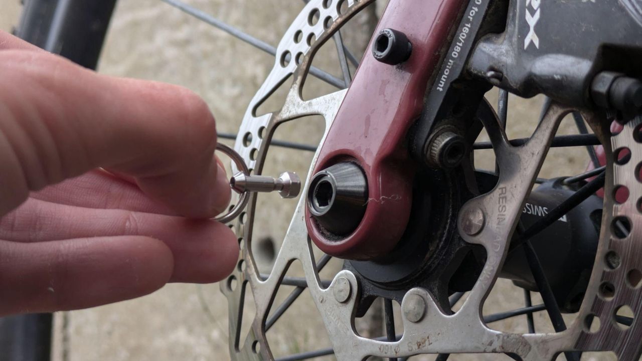 HexLox Anti-Theft system being fitted to a bike&#039;s thru-axle