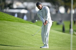 Tiger Woods chips to the green on the third hole in round one of the Genesis Invitational at the Riviera Country Club in Pacific Palisades, CA, on Thursday, February 15, 2024.