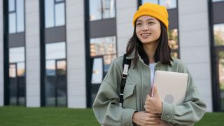 Student holding a laptop