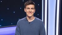 James Holzhauer smiles at the camera from behind his lectern on Jeopardy! Masters.