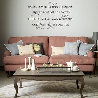 living room with pink sofa and wall quote