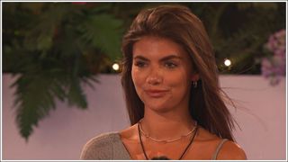 Love Island's Samie wearing a gold and crystal necklace as she sits at the Firepit in winter Love Island 2023
