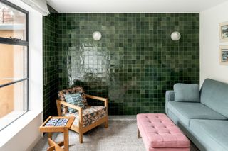 a small living room with tiled walls