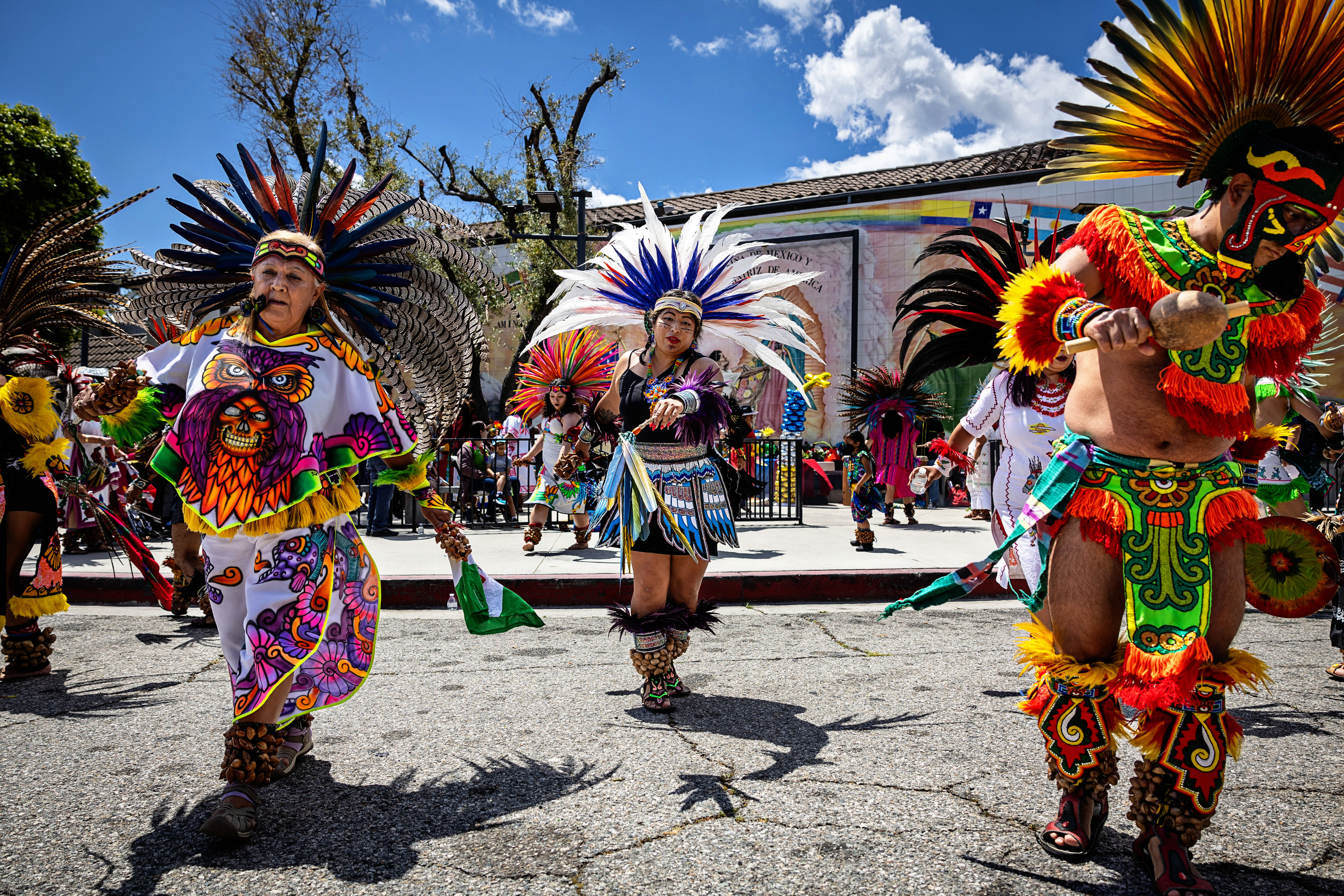Community members perform tradition Aztec dancing at during the Cinco De Mayo Fiesta in Los Angeles in 2024. 