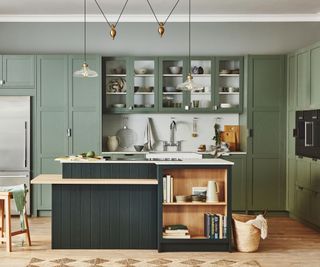 shaker kitchen with sage wall units and dark green island