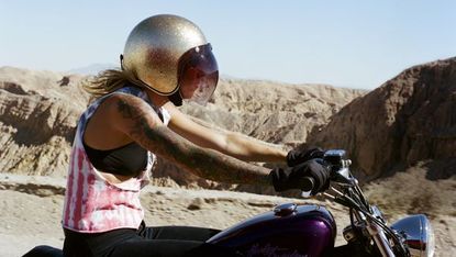 Motorcycle, Landscape, Fuel tank, Fender, Motorcycle helmet, Personal protective equipment, Travel, Motorcycle accessories, Sand, Helmet, 