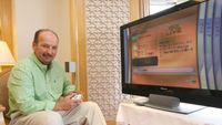 Peter Moore shows off an Xbox 360 in Japan