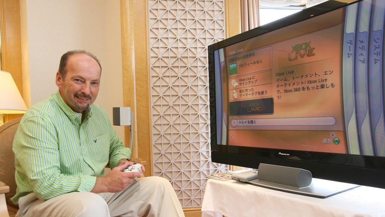 Peter Moore shows off an Xbox 360 in Japan