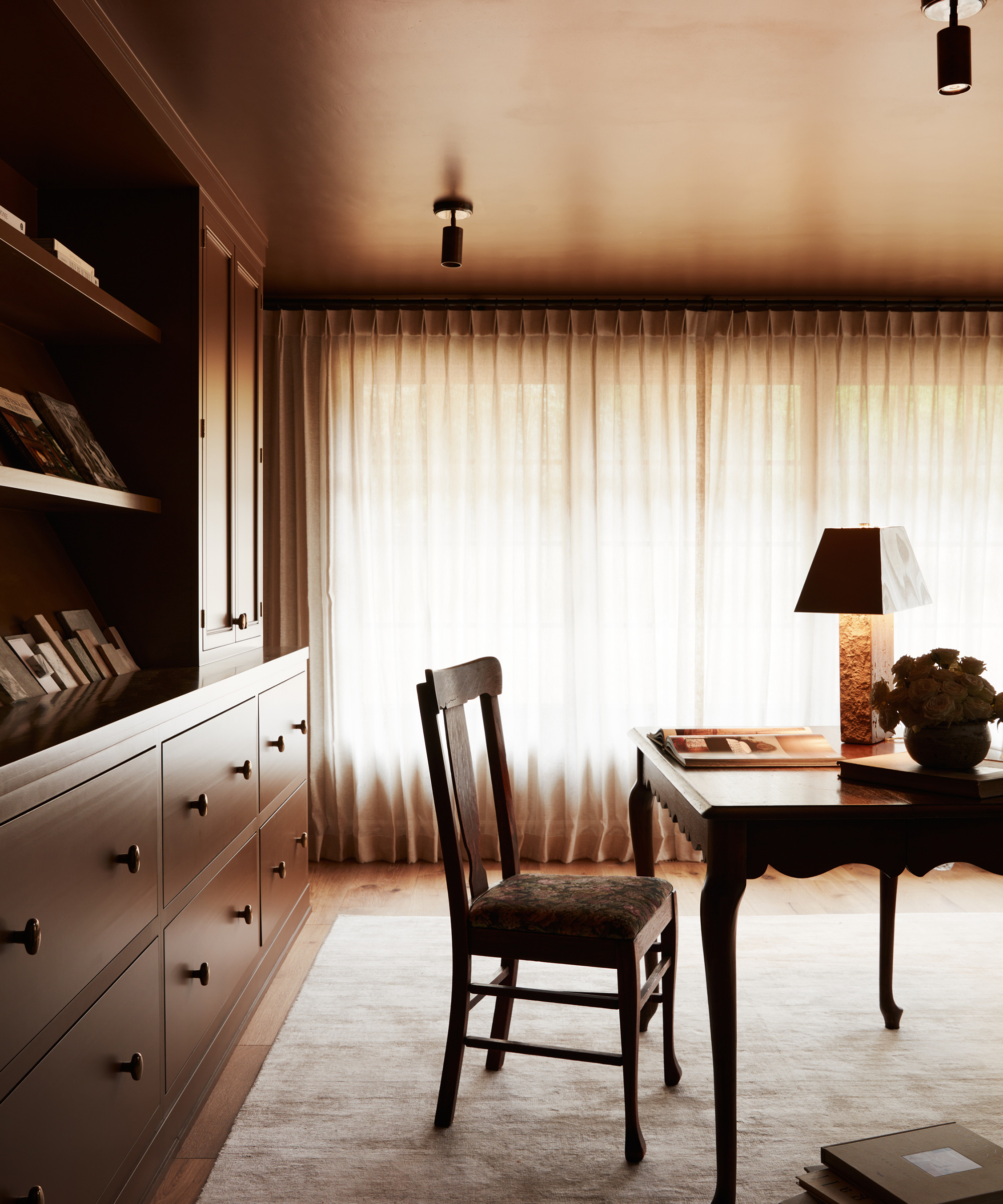 home office with brown ceiling and wood chair