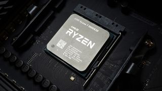 An AMD Ryzen 7 5800X3D processor seated into a black motherboard
