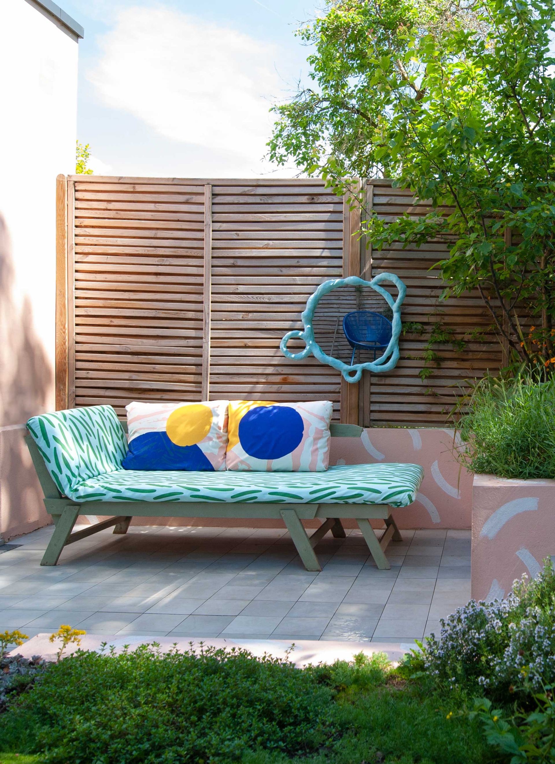 an outdoor space with colorful painted rendered beds