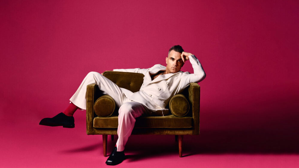 Robbie Williams lies on sofa
