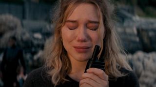 Lea Seydoux crying as she holds a radio in No Time To Die.