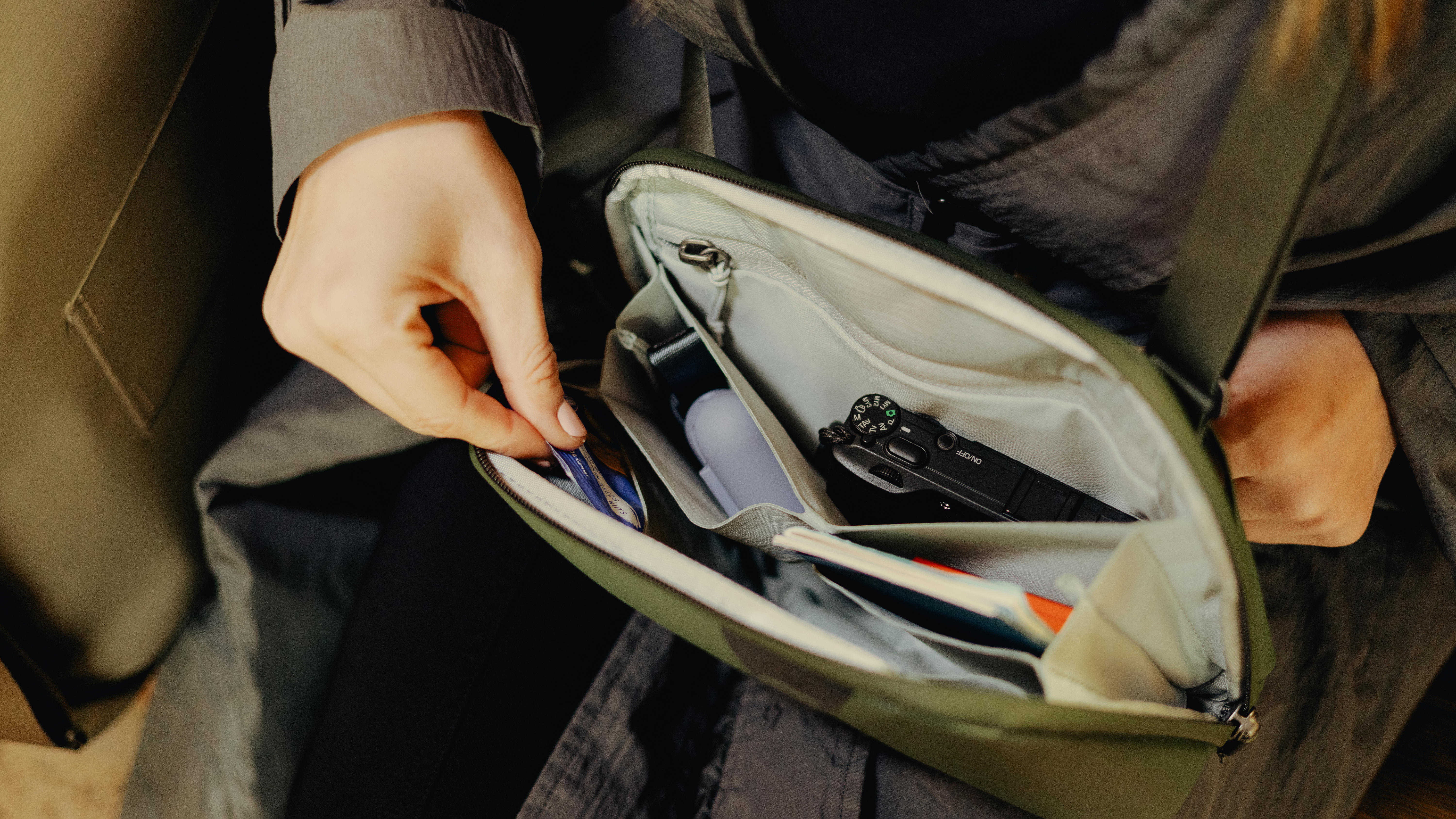 A person looks through the inside of the Peak Design Travel Crossbody