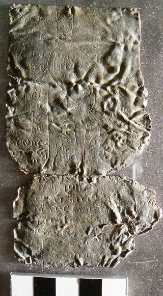 This tablet contains a curse directed at a Roman senator named Fistus, possibly the only known case of a curse targeting a senator. An eight-point star covers the deity's genitals and snakes project out of its head. The curse is written in Latin with Greek invocations.