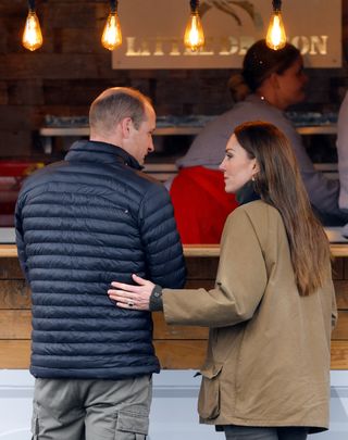 Kate Middleton is seen touching the small of Prince William's back