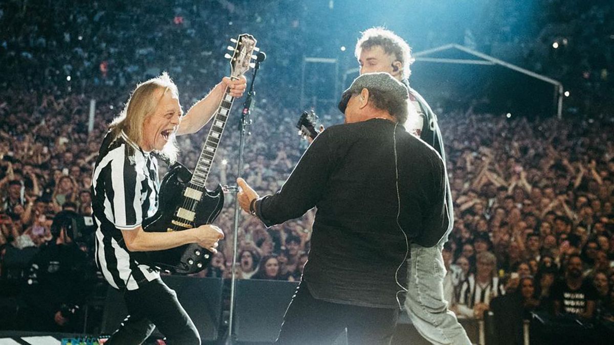 Sam Fender performing with Brian Johnson and his old guitar teacher