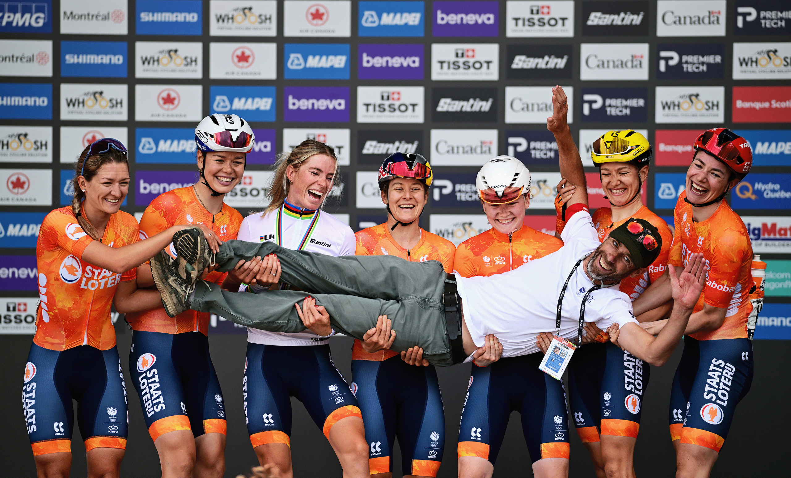 Gold medalist, Demi Vollering of Team Netherlands and her team-mates Amber Kraak, Femke De Vries, Riejanne Markus, Lieke Nooijen, Puck Pieterse, Karlijn Swinkels, celebrate on the podium supporting the Netherlands national team coach, Laurens ten Dam during the 99th UCI Road World Championships Montreal 2026 - Women Elite Road Race a 180.1km one day race from Brossard to Montreal on September 26, 2026 in Montreal, Quebec. (Photo by Tim de Waele/Getty Images)