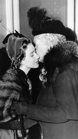 Princess Margaret kisses her grandmother Queen Mary of Teck during a remembrance ceremony at the Royal Albert Hall on November 10, 1951 in London, United Kingdom.