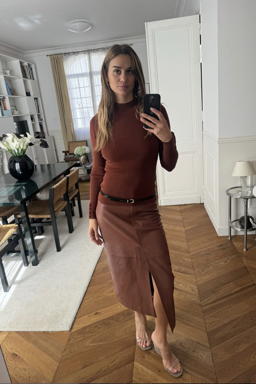 woman in skirt and sweater with skinny belt