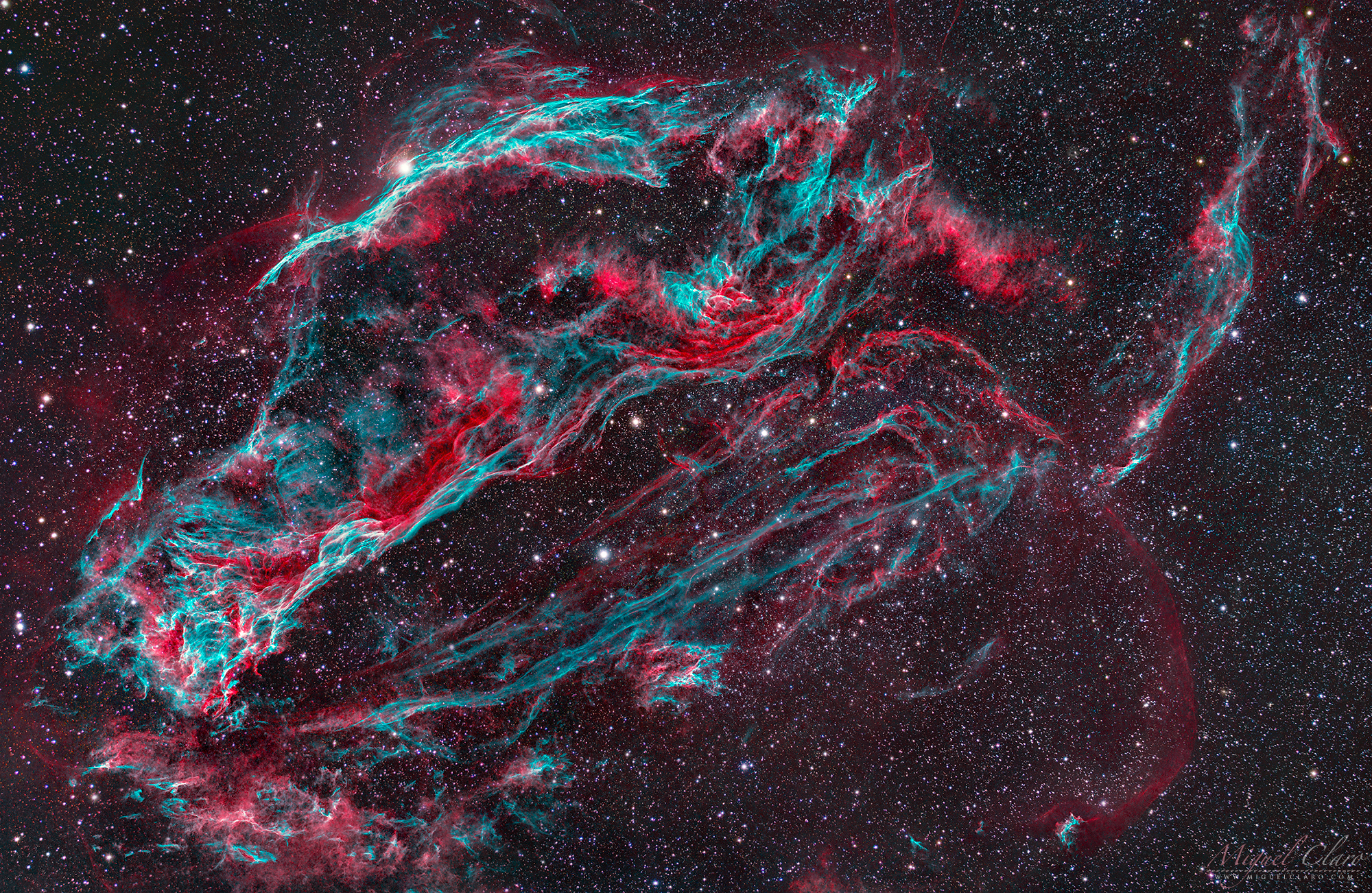 a colorful cloud of gas in space consisting of wisps of pinks and greens