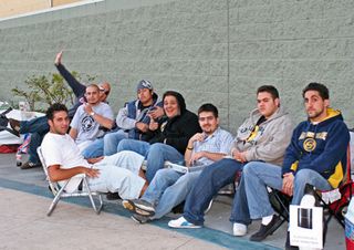 Ten hardcore customers wait for the PlayStation 3. The second from the left quit his job to wait in line. The third from the left postponed his engagement. (Two others are off camera)