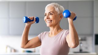 a senior woman holding dumbbells