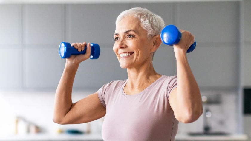 a senior woman holding dumbbells