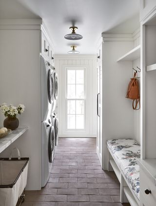 white laundry room with tiled floor, bench, washers, countertop, shiplap, coat rack