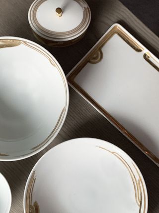 White porcelain tableware by Andre Fu with brown and gold gilded motifs