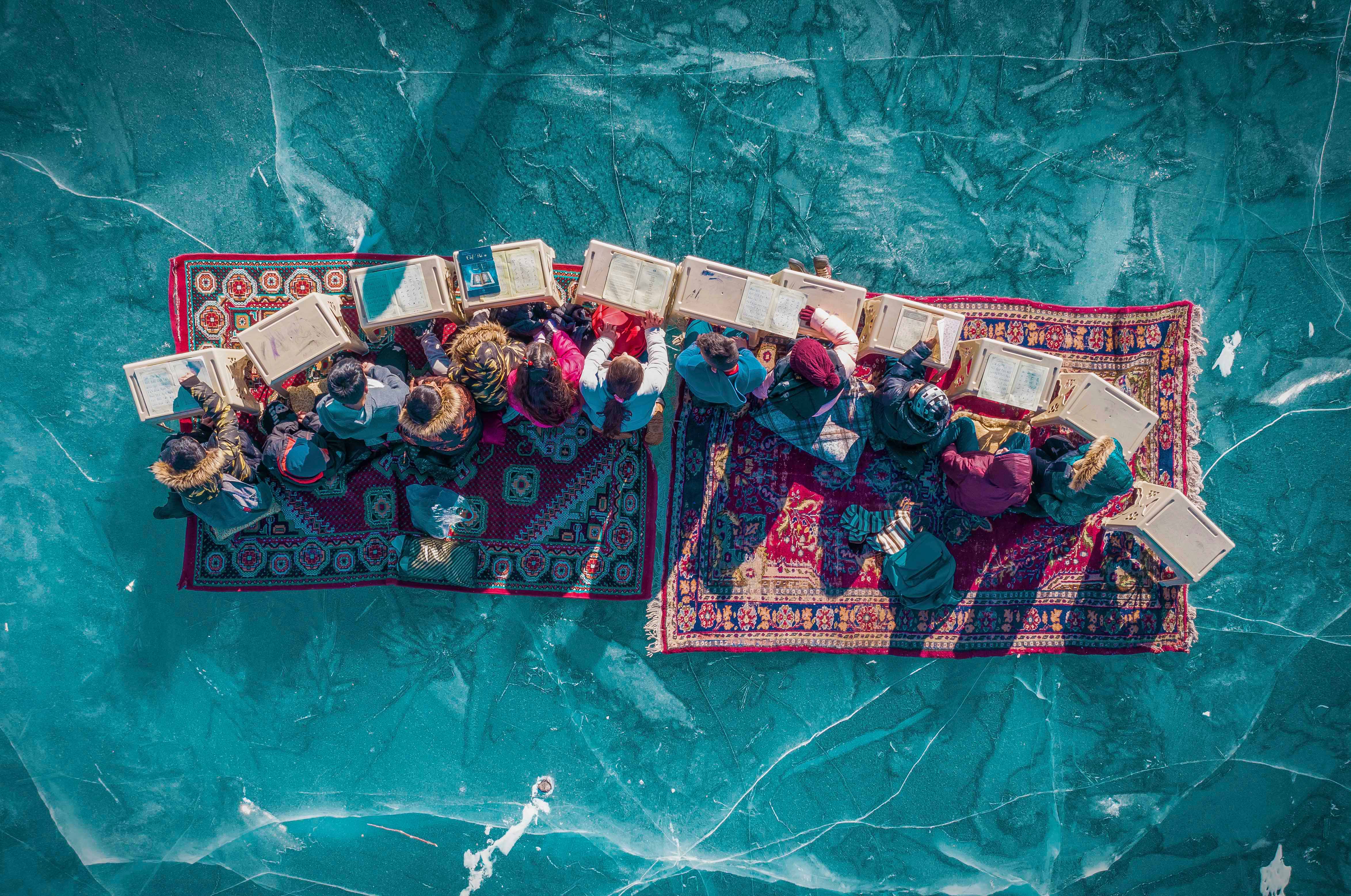 An aerial shot of children on a frozen lake from the SkyPixel Awards 2026