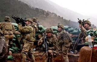 Soldiers with 2nd Battalion, 327th Infantry Regiment, 101st Airborne Division, return fire during a firefight with Taliban forces in Barawala Kalay Valley in Kunar province, Afghanistan, March 31, 2011.