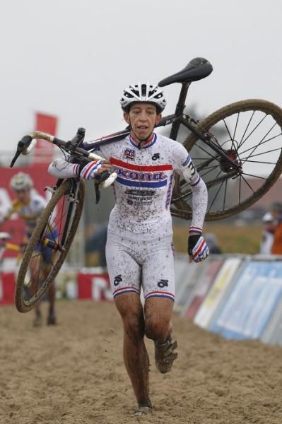 British champion Helen Wyman (Kona) runs through the sand.