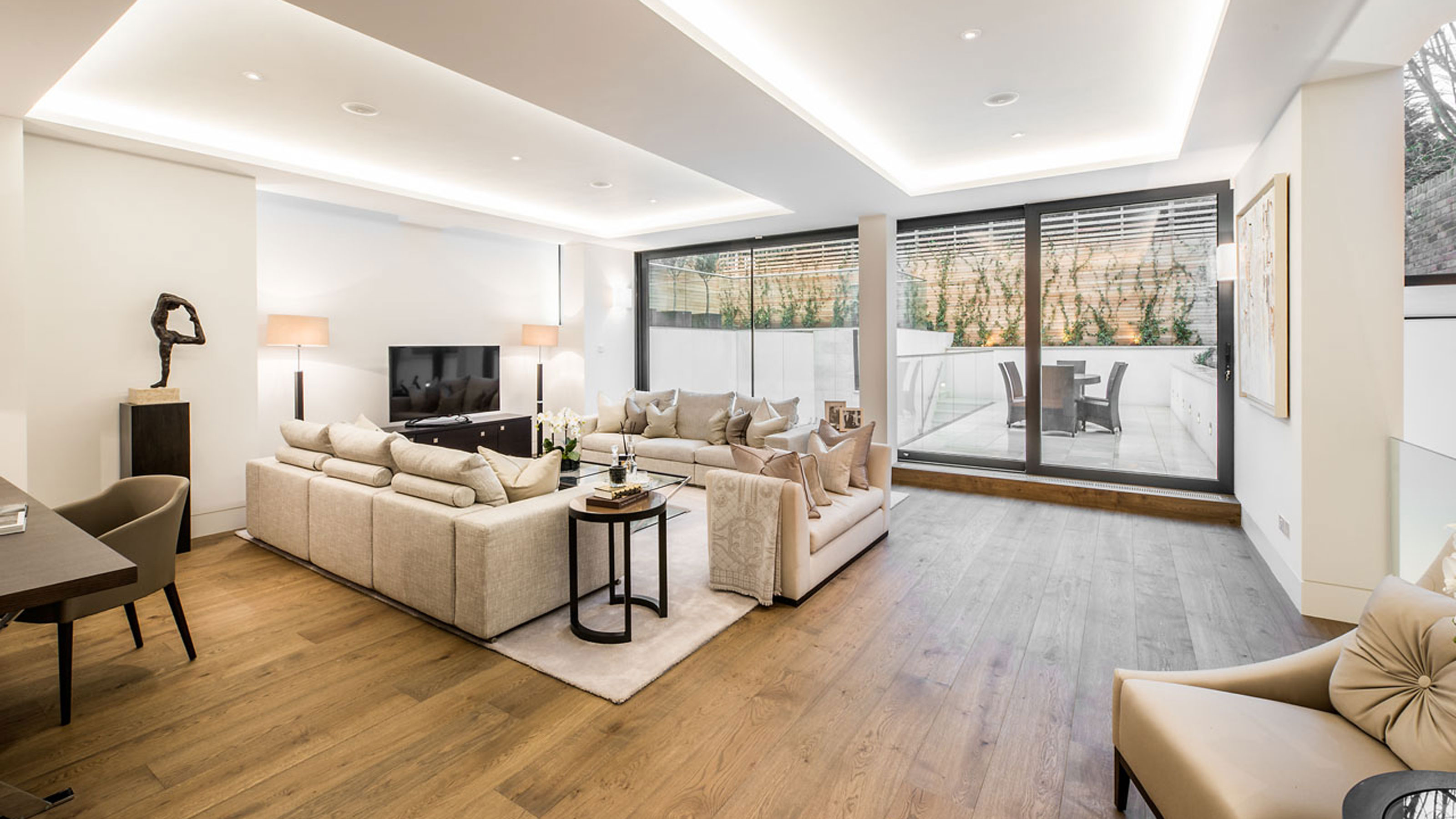 living room basement conversion with sliding doors to terrace
