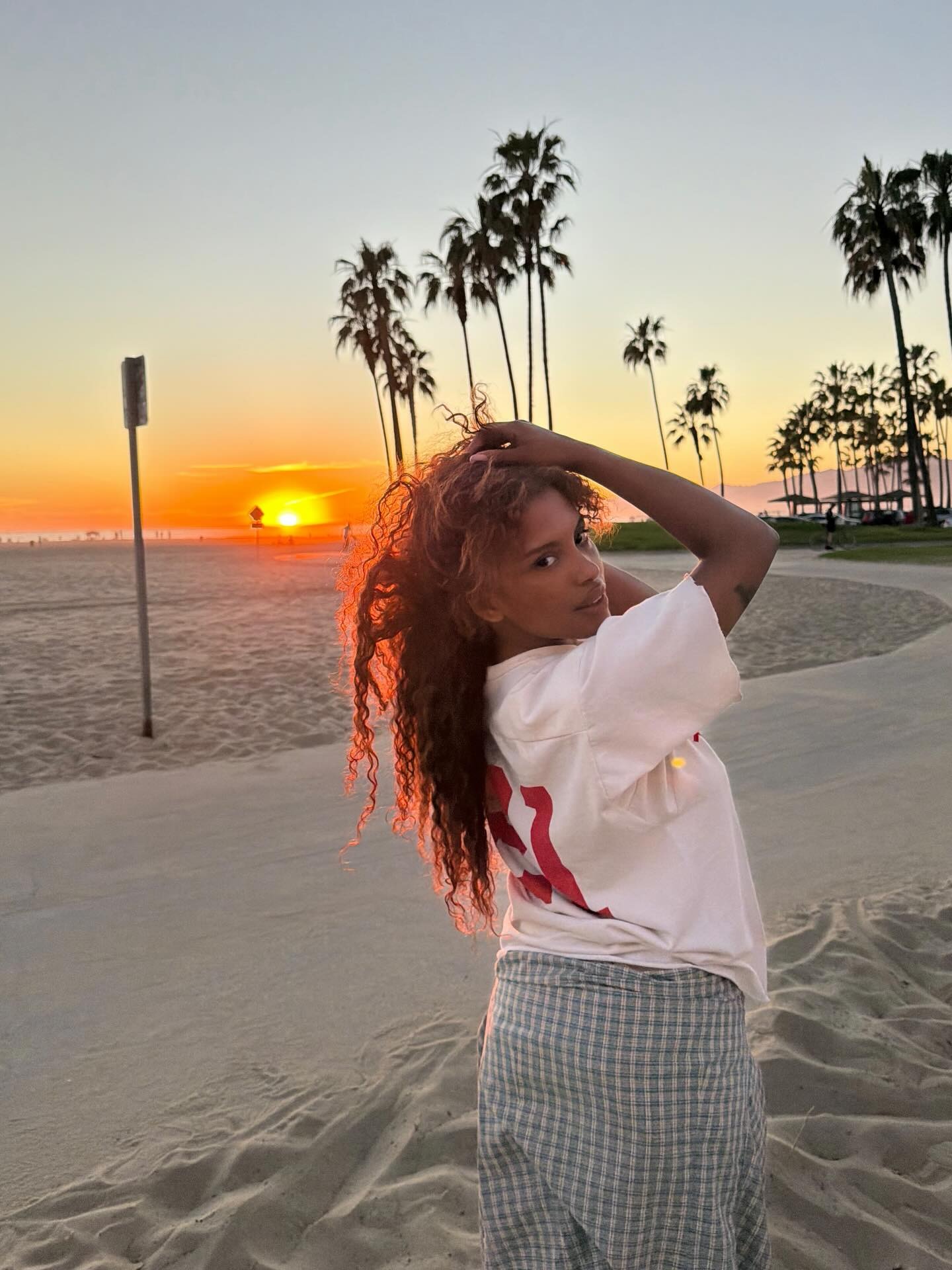 Creator @mv.tiangue in Los Angeles with a long, curly hairstyle