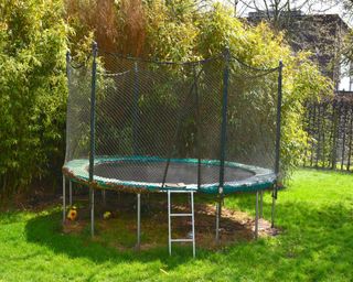 An above-ground trampoline in a yard