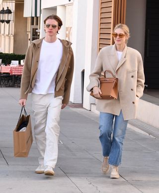 Kelly Rutherford wears beige flats with a beige wool blazer.