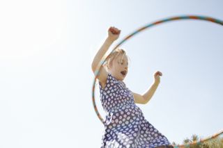 girl playing with hula hoop