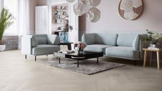 pale engineered wood floor in living room with pale blue sofa
