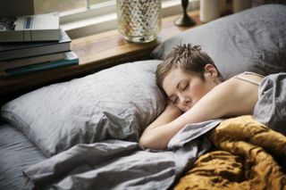Woman sleeping in bed during lockdown with vivid dreams