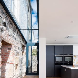 brick wall with glass ceiling and glass door
