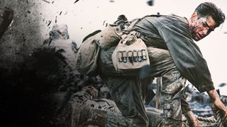 Andrew Garfield as wounded soldier Desmond Doss looking at an explosion behind him as he holds onto a rope.