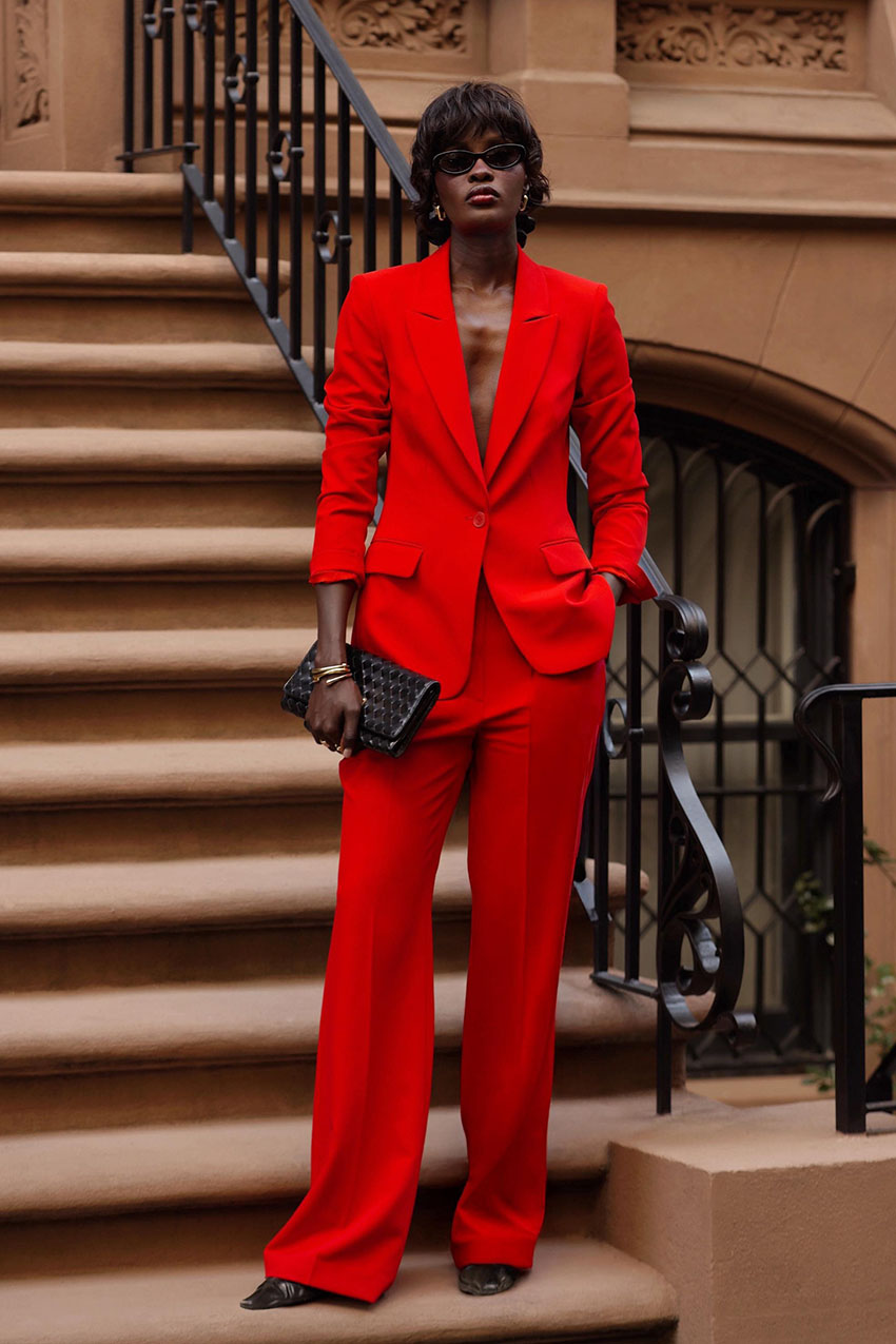 a woman holding an envelope clutch bag